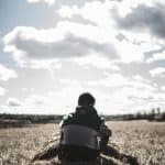 people man, back, nature, guy, boy, grass, field, farm, landscape, trees, sitting, sky, clouds, outdoor, shadow, sun